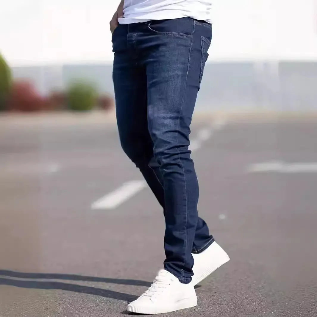 Men's dark blue cotton skinny jeans with elastic waistband shown on model