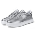 Women's white leather flat lace-up shoes on a solid background.
