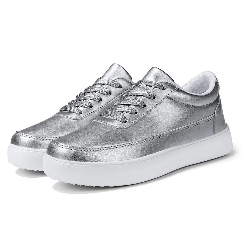 Women's white leather flat lace-up shoes on a solid background.