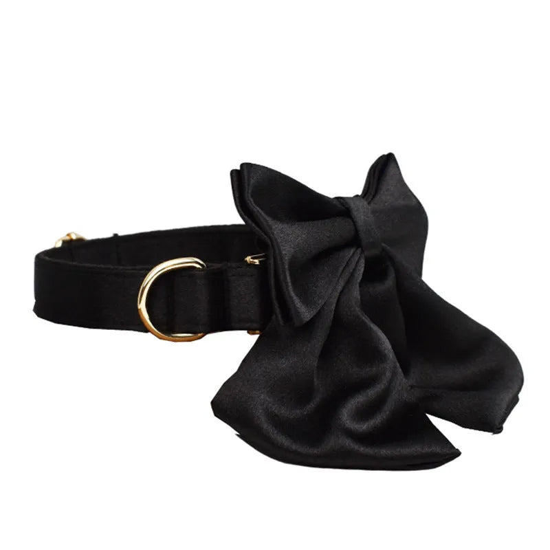 A cloth dog collar, matching leash, decorative bow, and dog vest set laid out flat, showing the coordinated design.