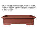 Large rectangular purple clay flowerpot for bonsai or garden plants, shown in a garden setting.