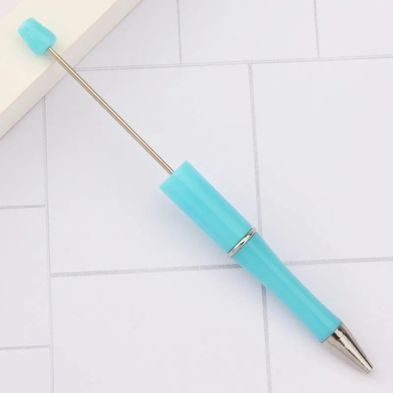 Ballpoint pen with colourful spinning plastic beads on barrel, shown in a gradient purple finish.