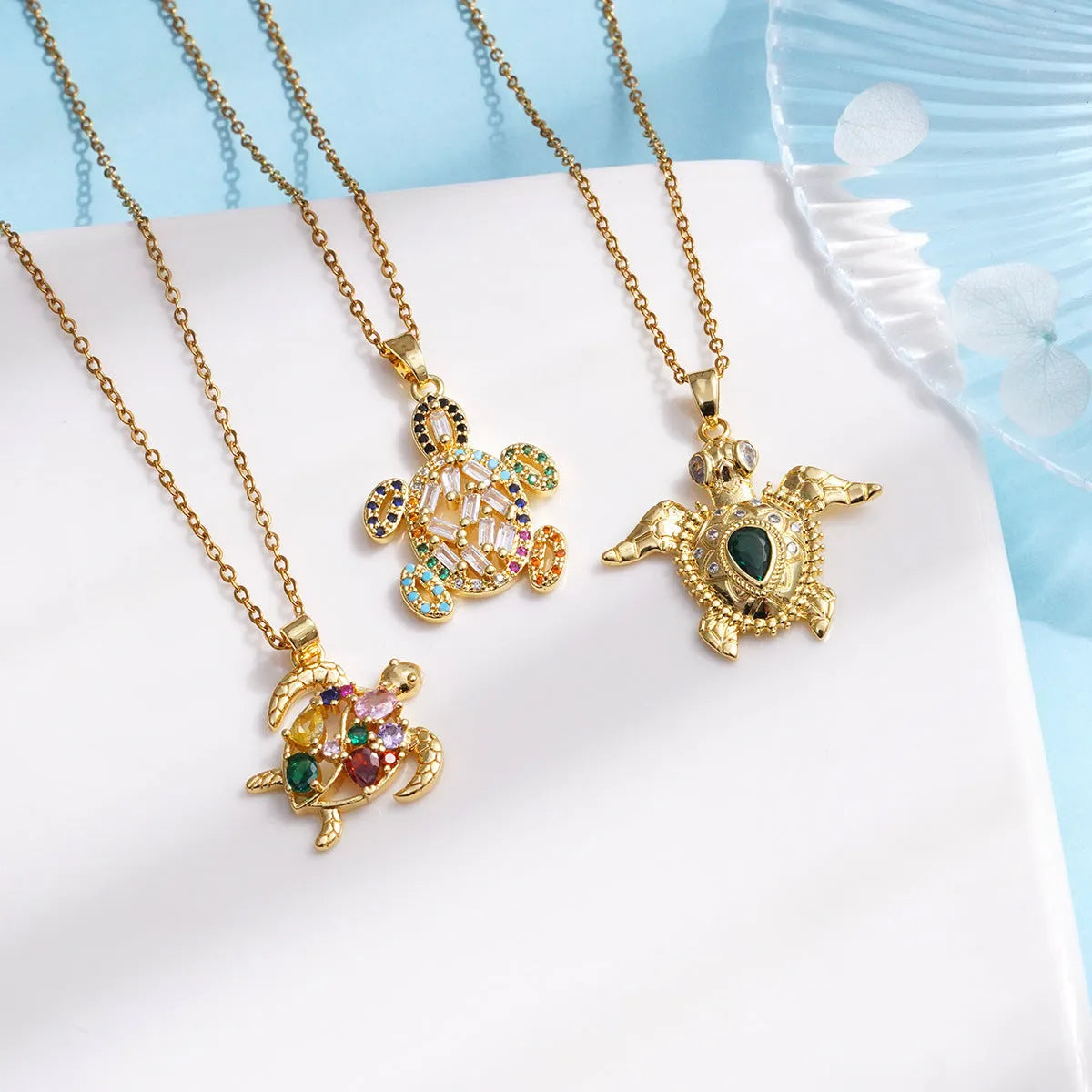 Gold-plated copper sea turtle necklace with zirconium-encrusted inlay on a titanium steel O-link chain