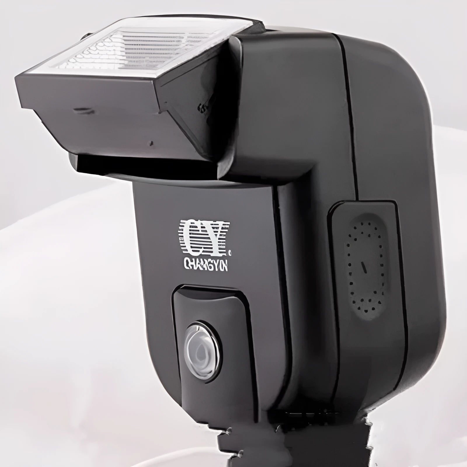 Compact black hot shoe camera flash unit with a head rotated upwards for bounce lighting.