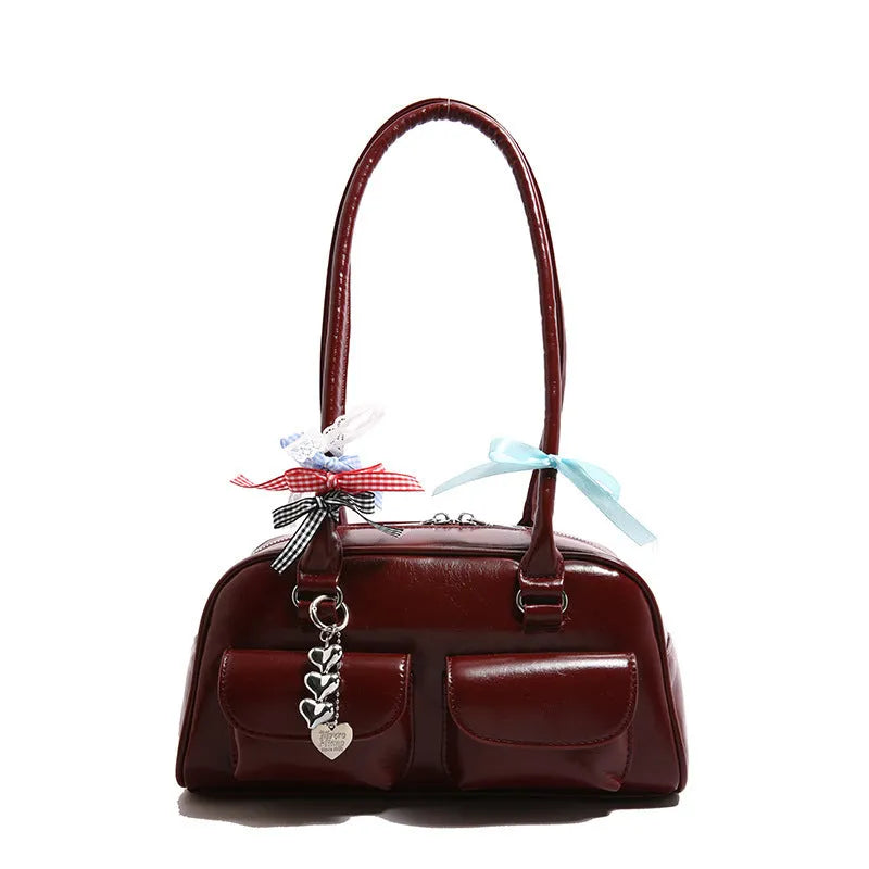 A women's black PU leather pillow-shaped flap handbag with a double shoulder strap.