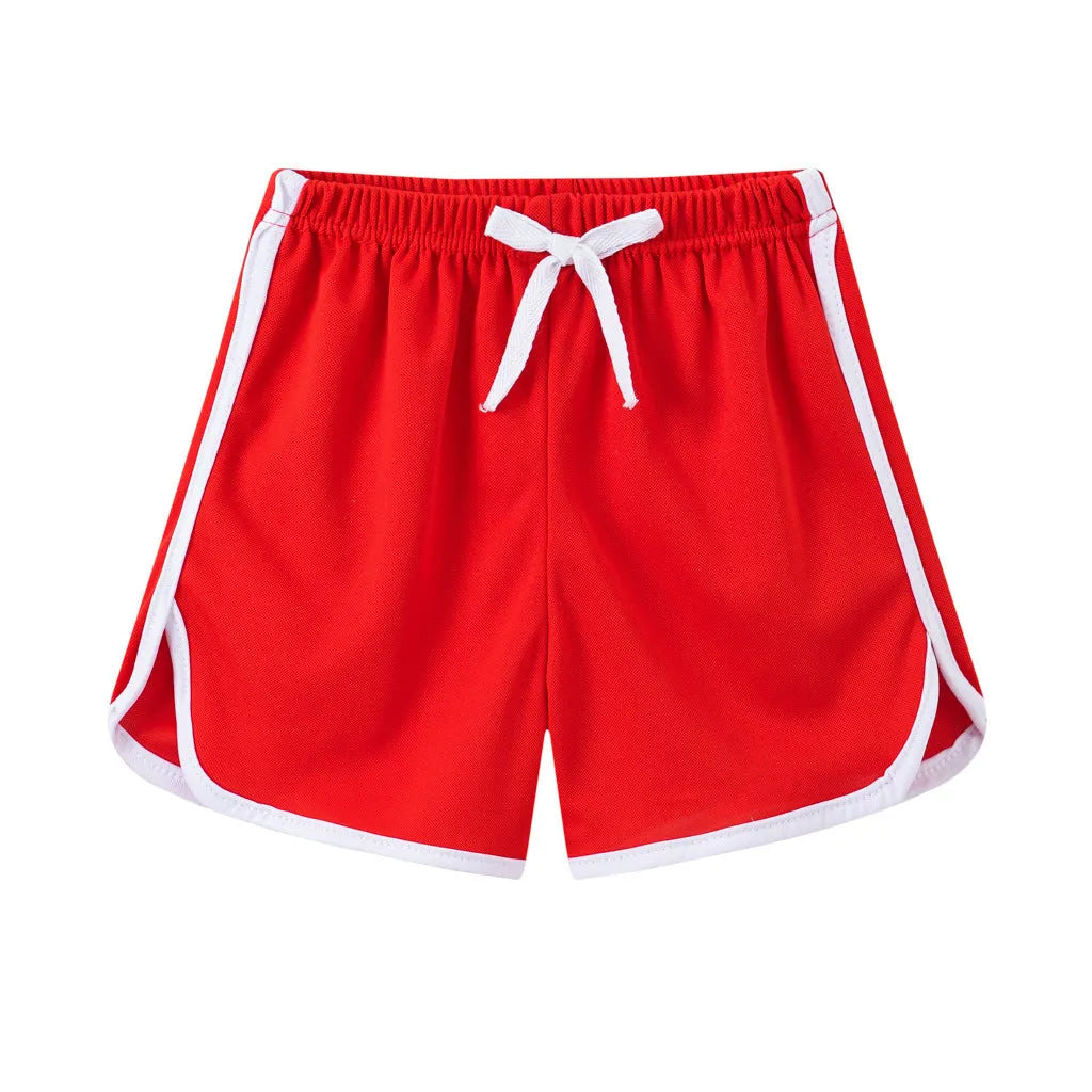 Children's colourful polyester beach shorts showing patterns like leopard print, stripes, and pineapples.