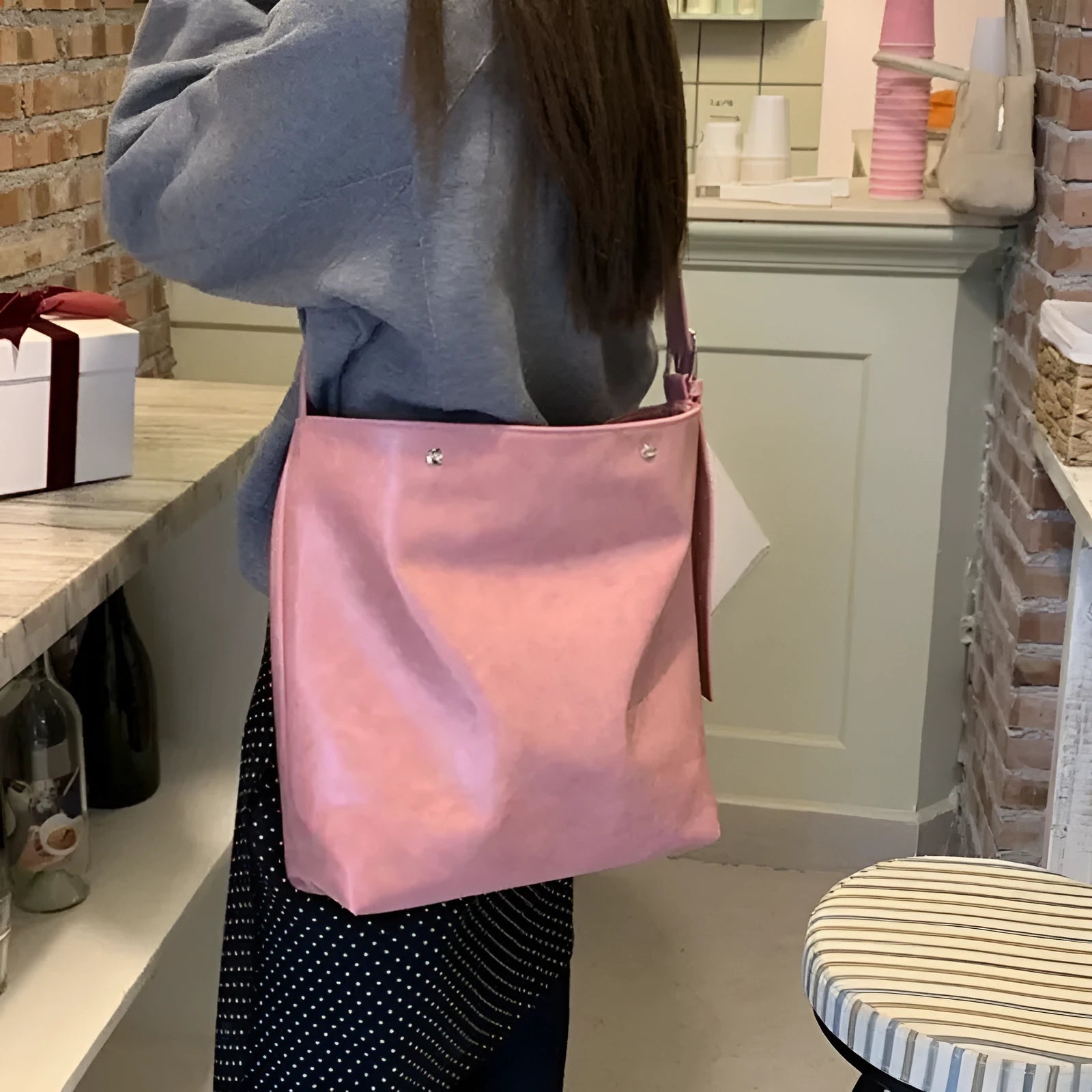 Corduroy one-shoulder commuter bag in pink colour showing textured fabric and structured shape