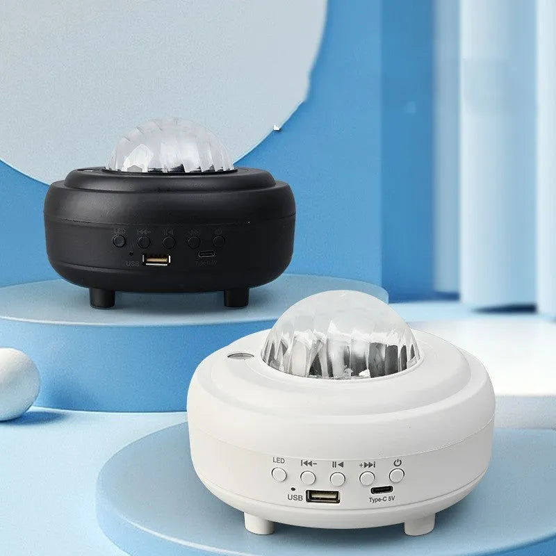 White galaxy star projector with Bluetooth speaker showing star projection on wall