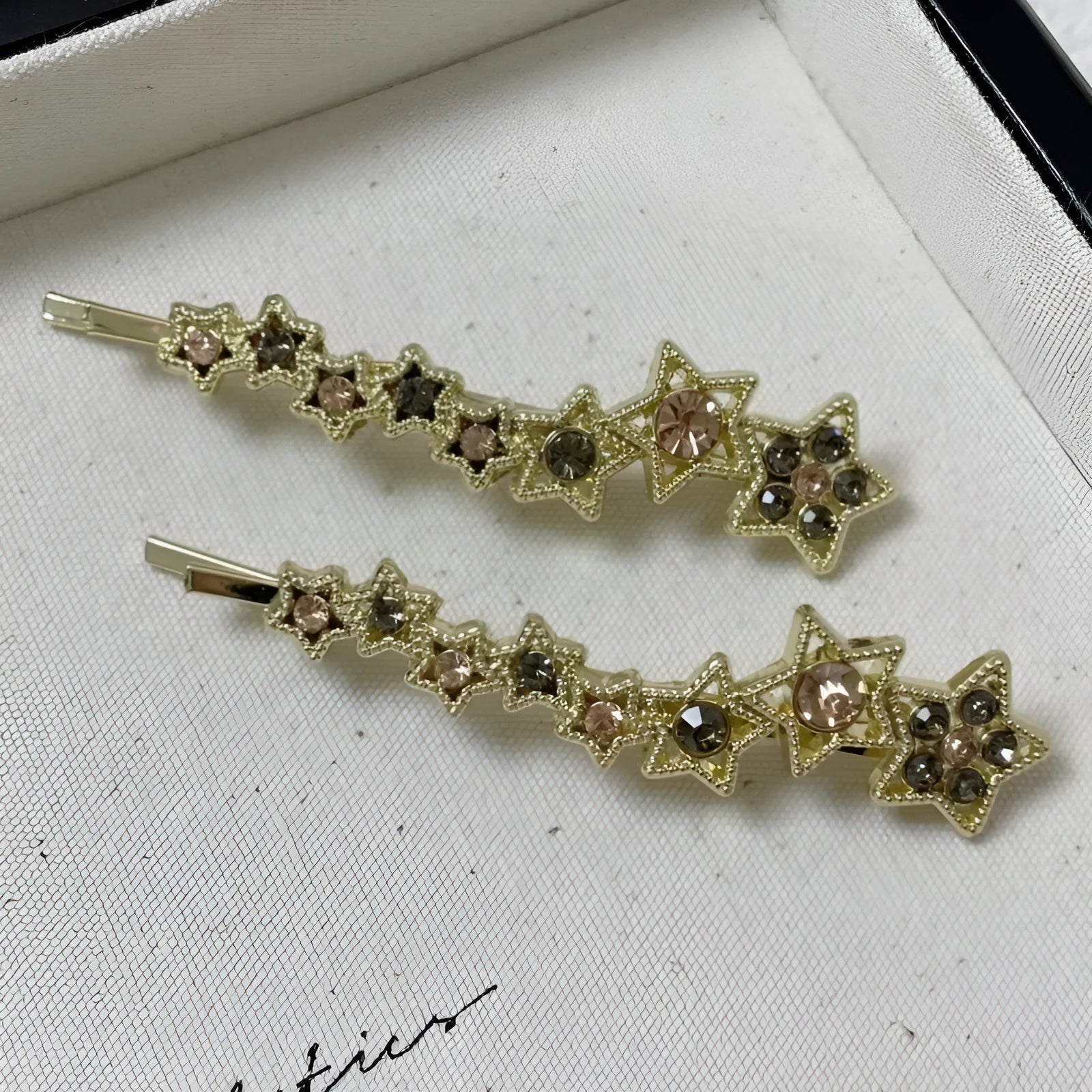 Gold electroplated hair barrette with star decoration and side clip design for bangs