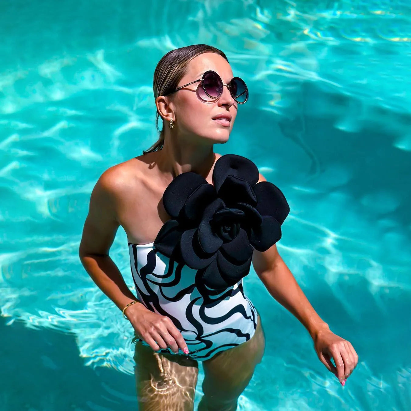 One-piece floral swimsuit in a solid colour with a skirt option on a mannequin.