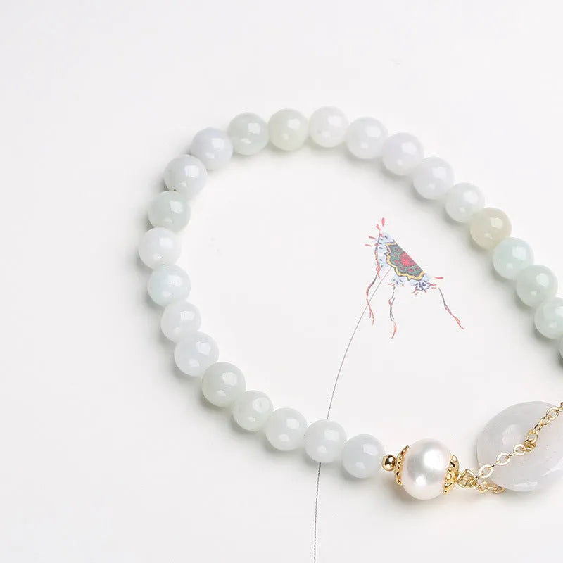 Women's natural emerald peace buckle pearl bracelet with geometric jade pendant on wrist