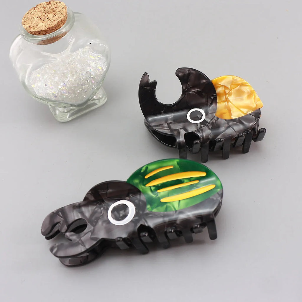 Handmade cellulose acetate beetle grip accessory in green, orange or white insect biology colours
