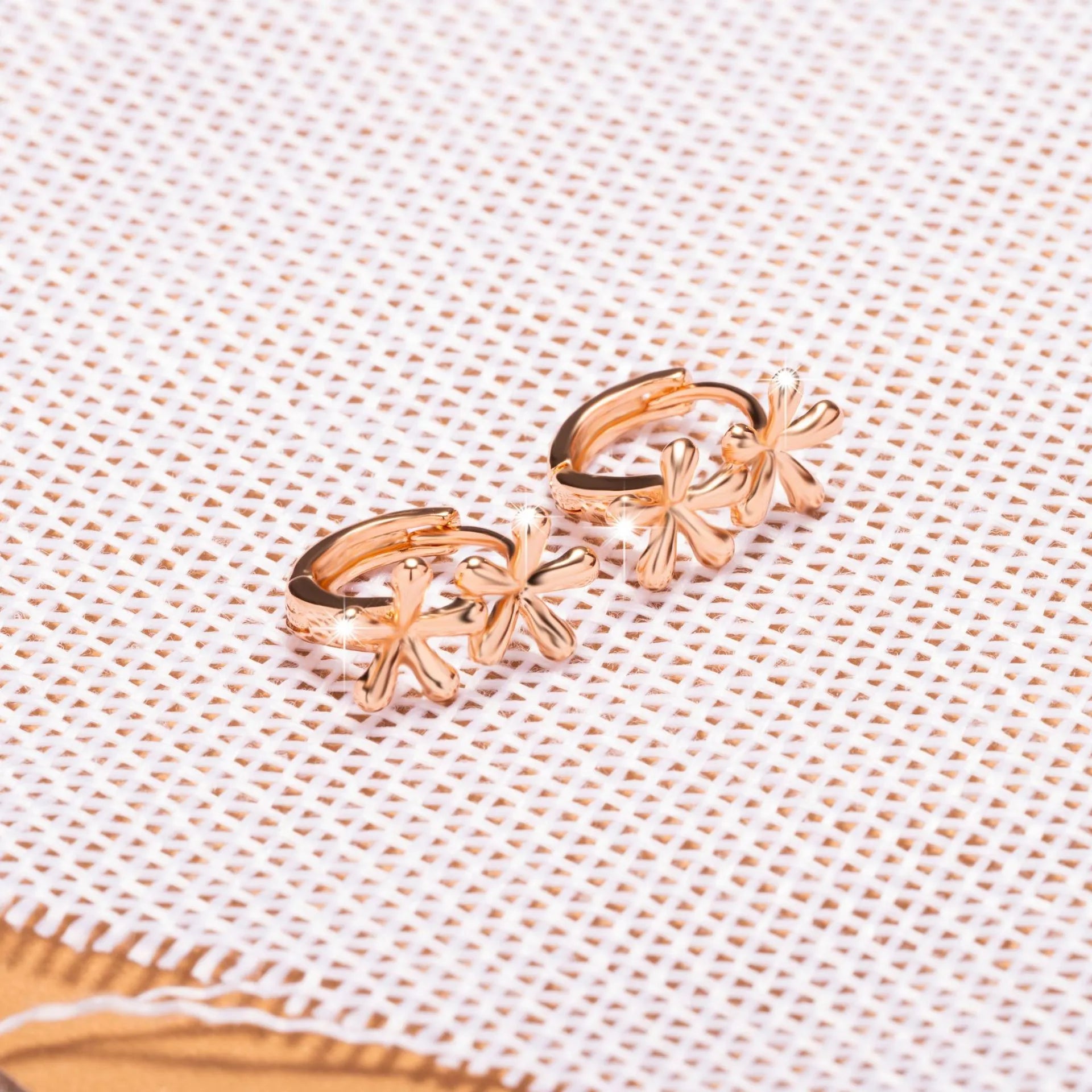Rose gold coloured circular waterdrop flower earrings with an electroplated finish.