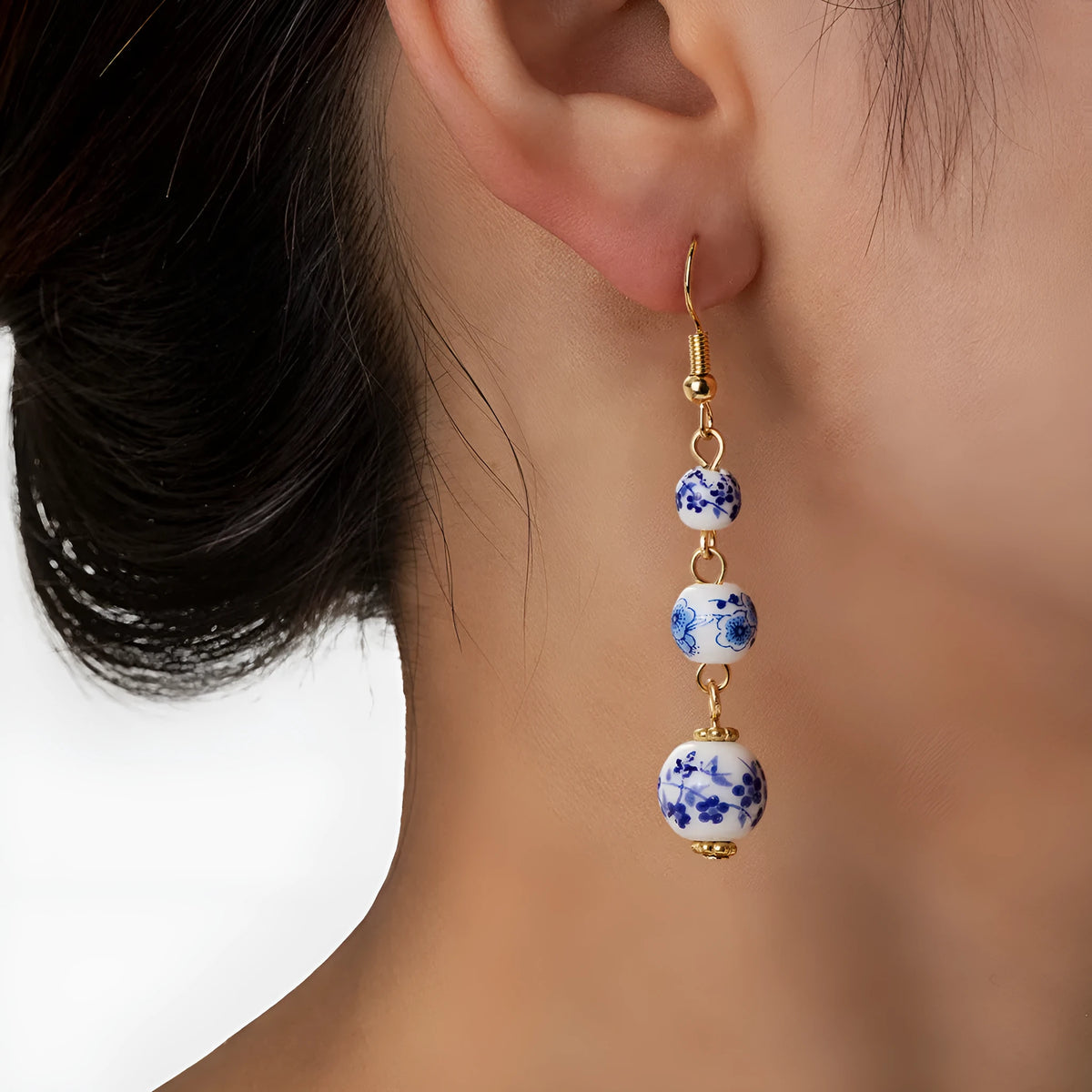 Long blue and white porcelain ceramic bead earrings with geometric Chinese-style design.