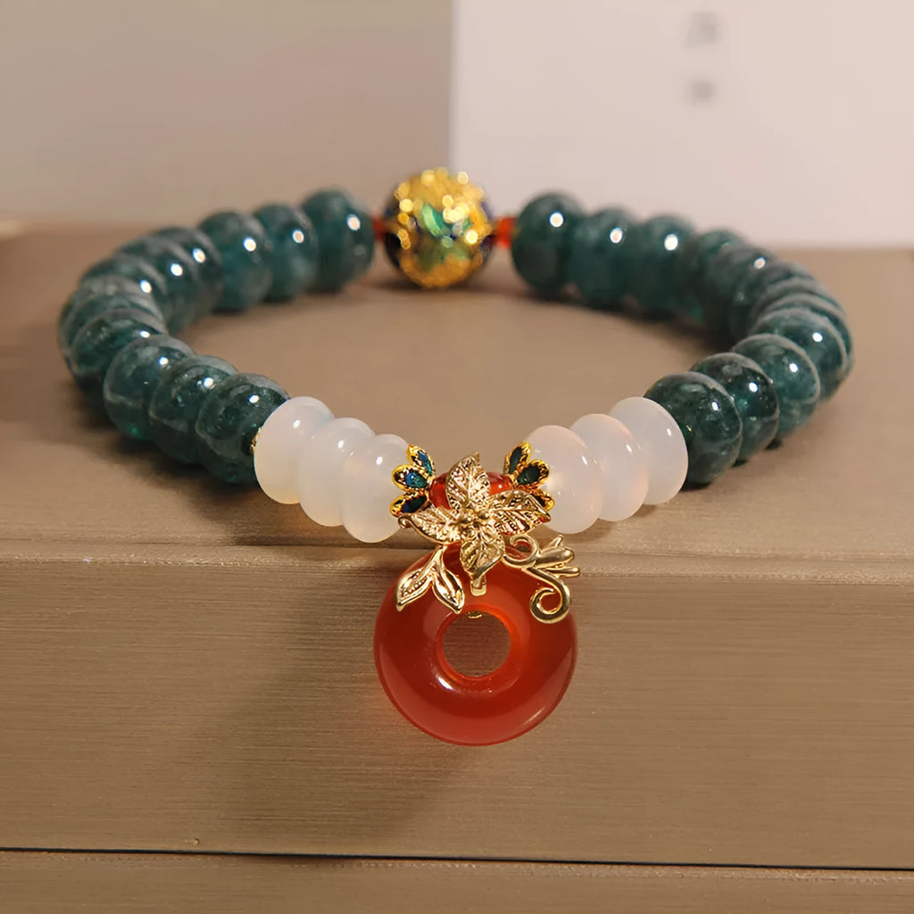 Blue water jade and red agate stone bracelet with peace buckle closure on crystal band
