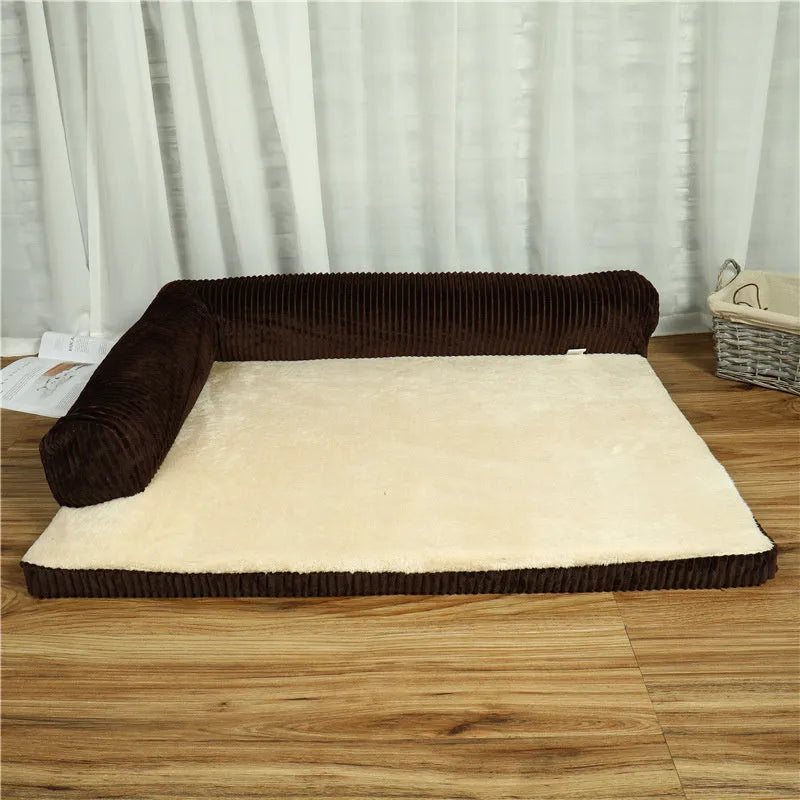 Corduroy pet sofa dog bed with a raised bolster, shown in a grey colour on a wooden floor.