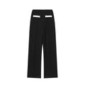 Women's beaded top and high-waisted trouser co-ord suit in contrasting colours, street fashion style.