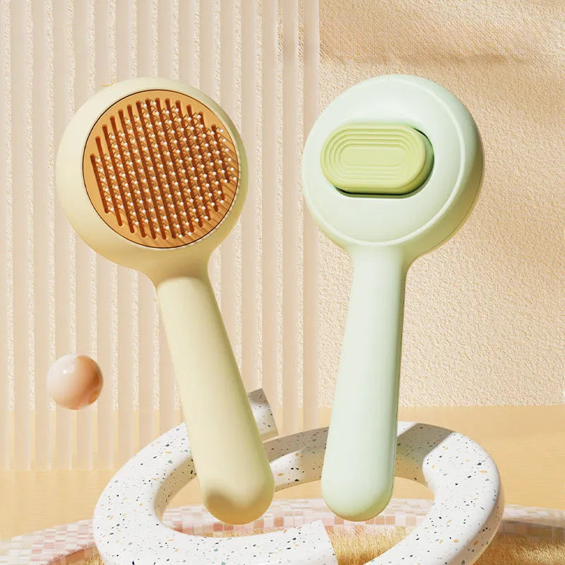 Yellow stainless steel cat grooming brush with non-slip handle for hair removal.