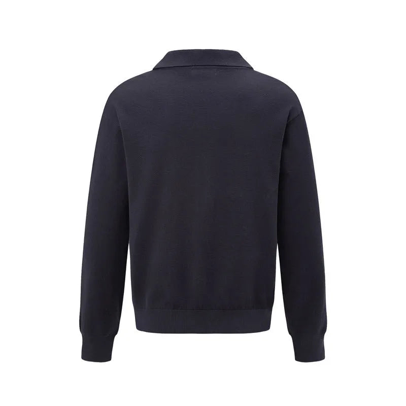 Man wearing a loose black pullover bottoming shirt for casual layered outfit.