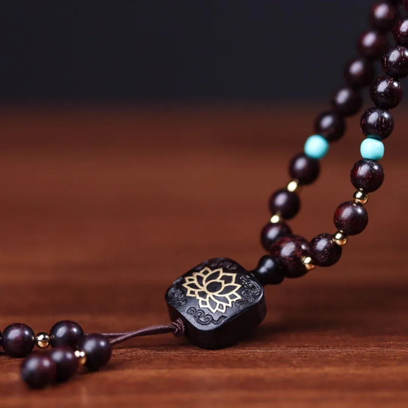 DIY kit showing 108 small 0.6 cm Zambia Rosewood beads for making a flat lotus pendant Buddha bead bracelet.