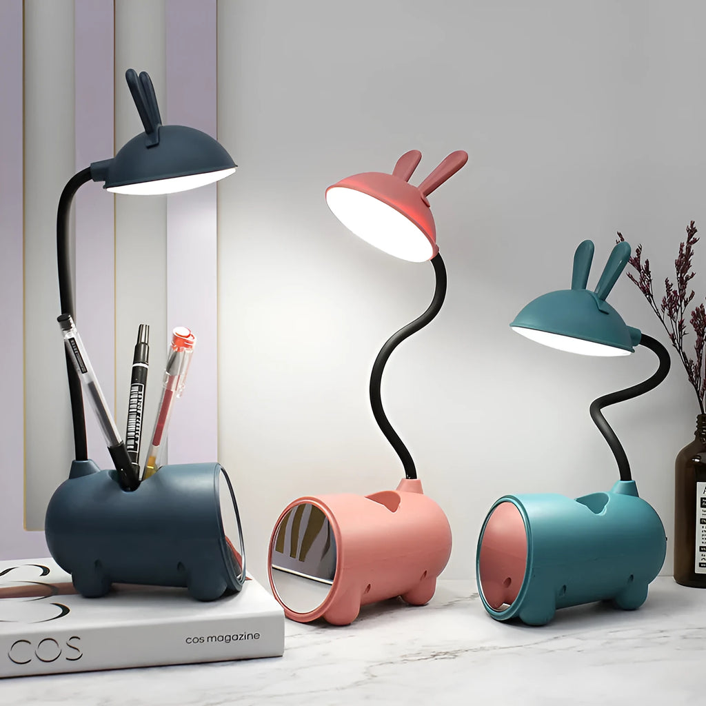 Cartoon-style USB desk lamp with pen storage compartment in green, blue, or pink colour options