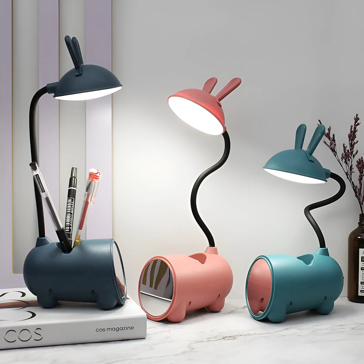 Cartoon-style USB desk lamp with pen storage compartment in green, blue, or pink colour options