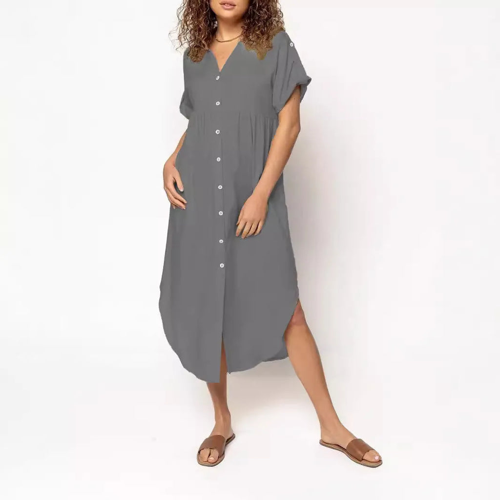A loose-fitting, solid-colour mid-length casual dress with a front button closure and regular sleeves.