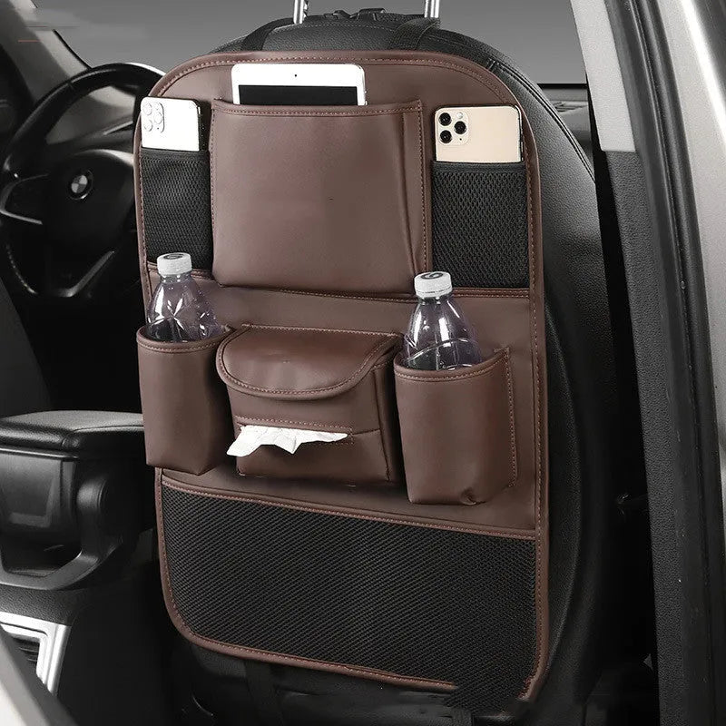 Synthetic leather car seat back storage bag hanging on the back of a grey car seat.