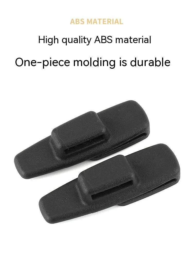 Two black plastic car safety belt clips for adjustable seat belt tension.