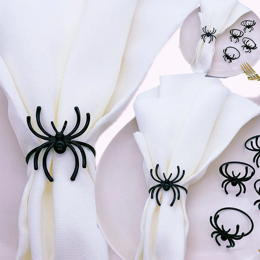 Set of six black alloy napkin rings with spider pattern design for Halloween table decoration