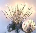 LED decorative tree light with simulated silver branches in vase displaying multiple colour options