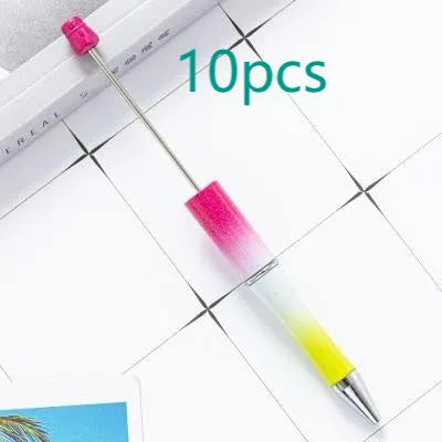 Ballpoint pen with colourful spinning plastic beads on barrel, shown in a gradient purple finish.