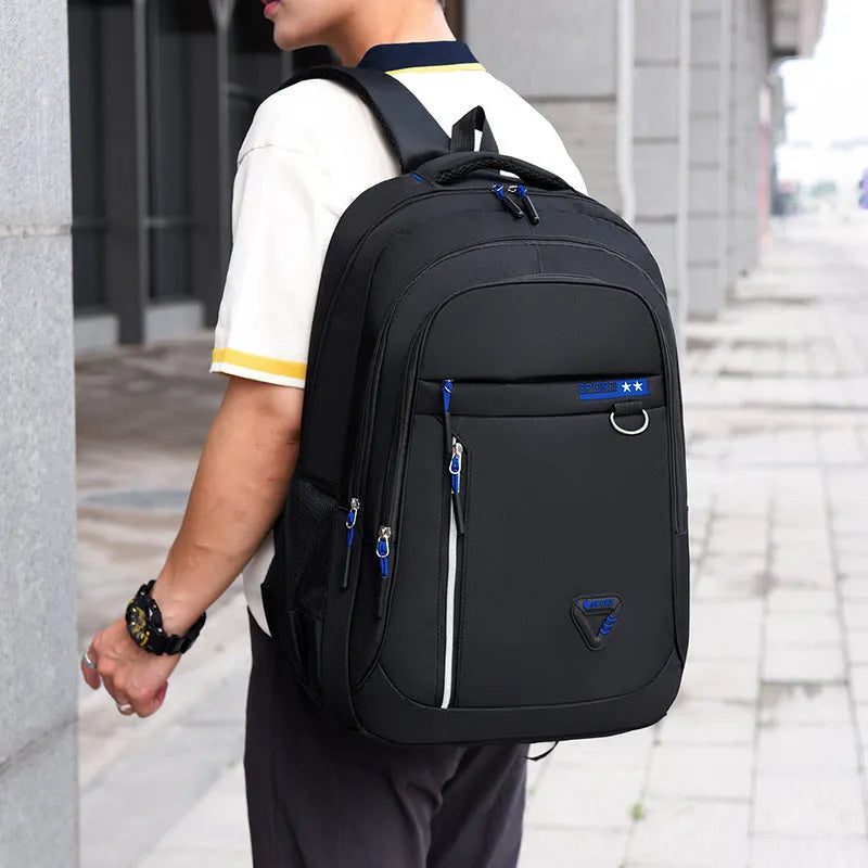 Men's Oxford cloth schoolbag in black with letter pattern, showing large capacity and air pillow straps