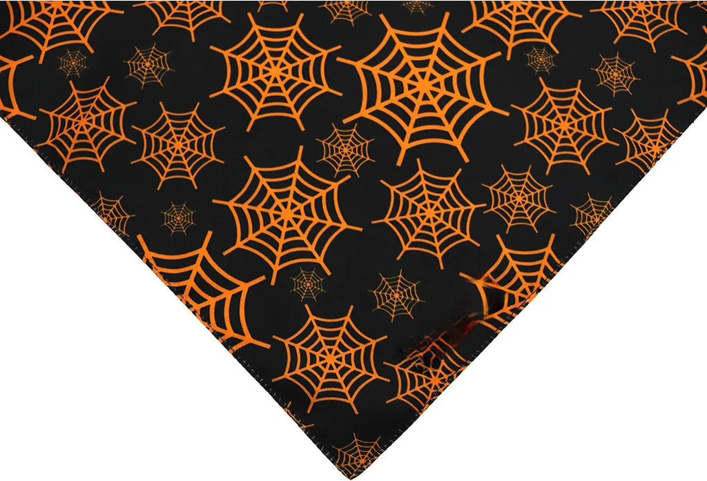 Halloween reversible dog bandana with pumpkin and spider web patterns in black and orange colours