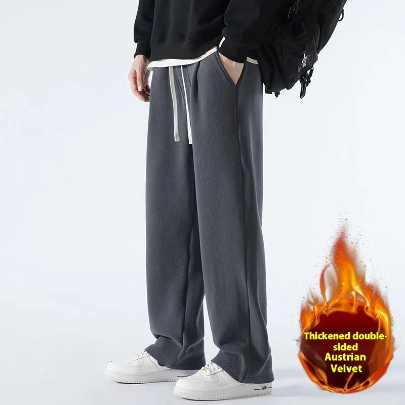 Man wearing loose apricot fleece-lined sports trousers with a drawstring waistband.