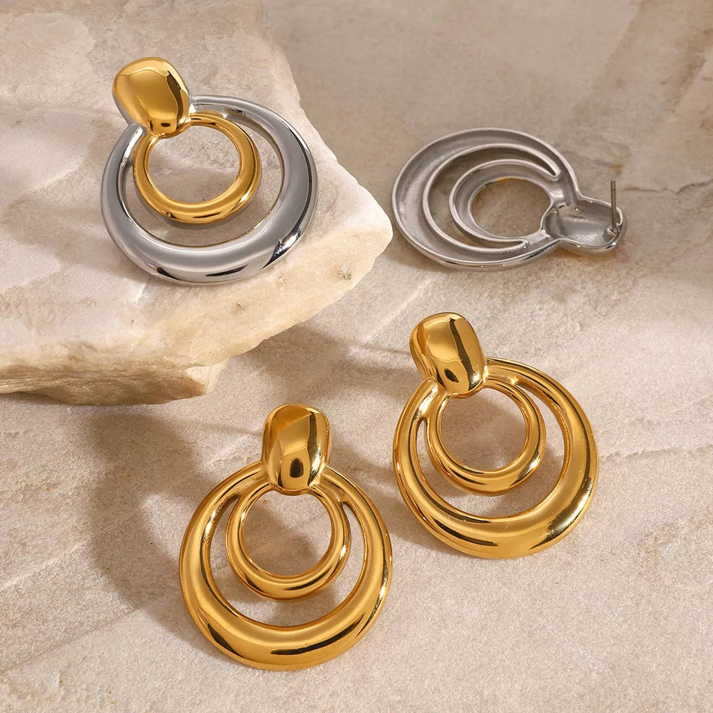 Golden round stud earrings with double-layer hollow construction and contemporary geometry design