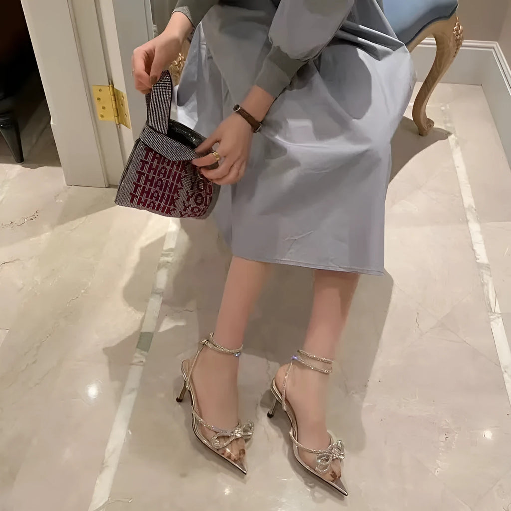 Women's black stiletto heel sandals with a pointed toe and an adjustable silk back bandage buckle.
