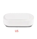 White portable ultrasonic cleaner with touch button next to jewellery and glasses on a table.