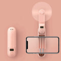 Green folding mini USB fan with plastic blades on a white background.
