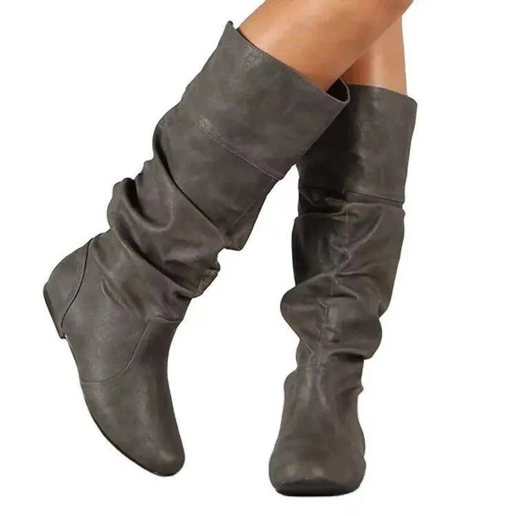 Women's flat heel slip-on ankle boot in artificial PU leather with a round toe and high cylinder sock.