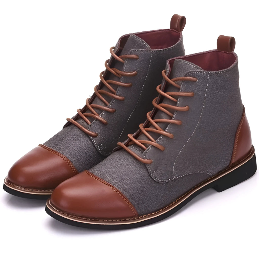 A pair of large leather boots for men with belt buckle detail and a rubber sole.