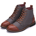 A pair of large leather boots for men with belt buckle detail and a rubber sole.