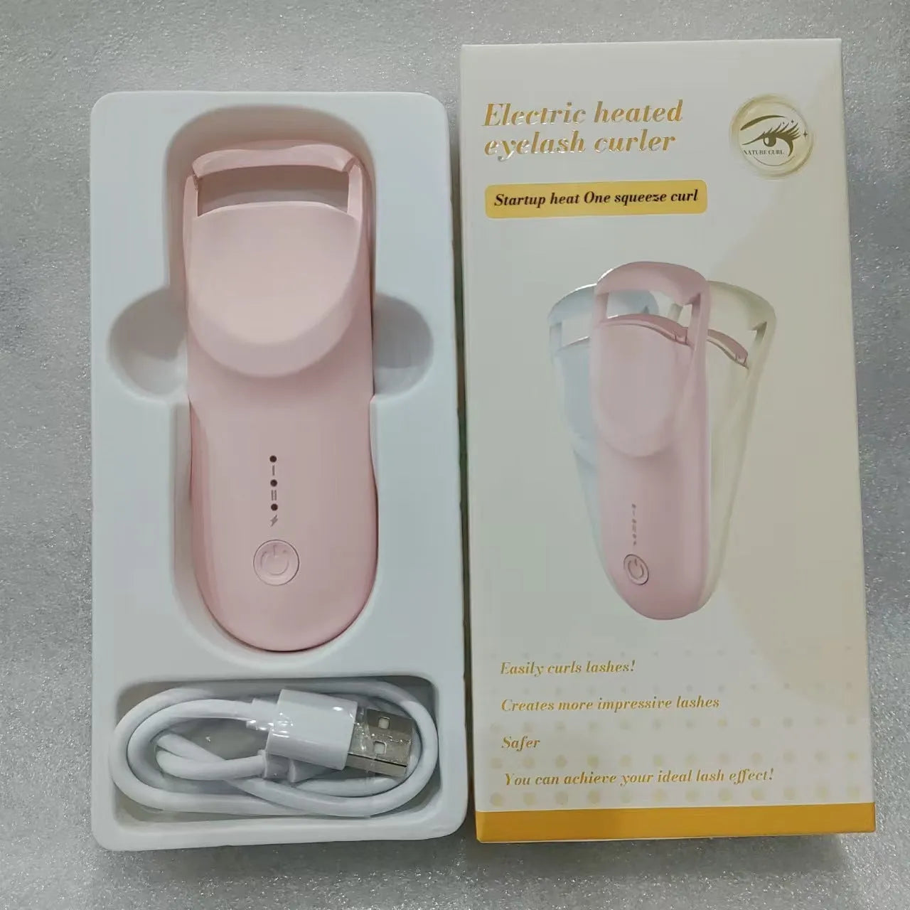 Electric heating eyelash curler with ceramic element in vanilla apricot colour with LED indicator light
