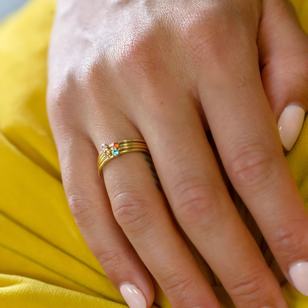 Titanium steel geometric engraved ring with a December birthstone, shown in a superimposed design.