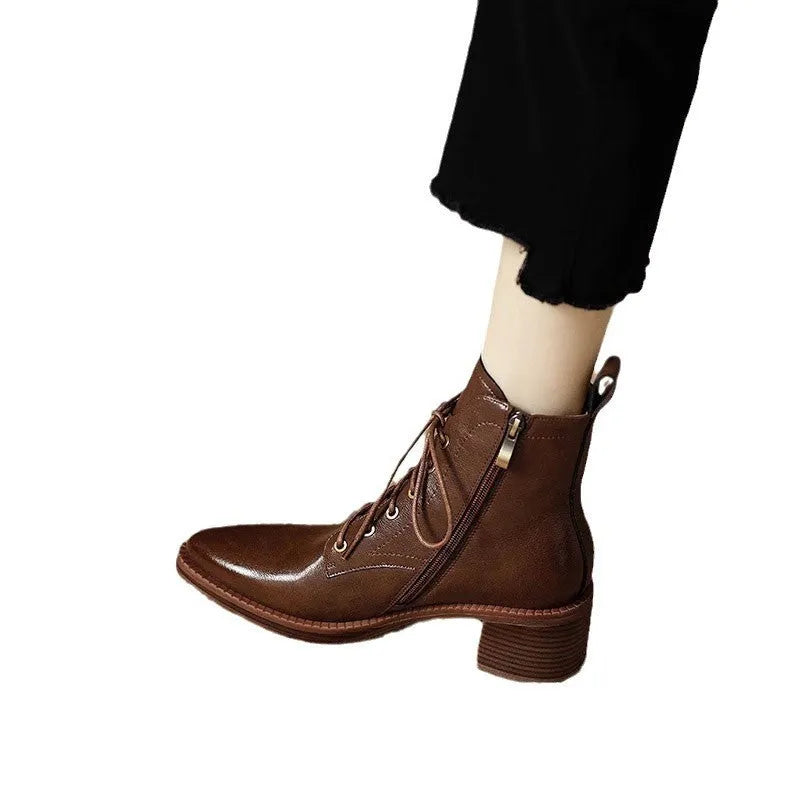 Women's black pointed toe short tube boots with 5.5cm heel on wooden floor