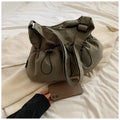 Green ultra-light pleated crossbody cloth bag showing split pocket and foldable design.
