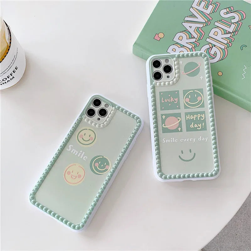 Green TPU iPhone case with smiley face and geometric pattern inside a polka dot frame.