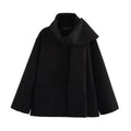 Women's long grey coat with artificial fur collar, shown with pockets and street-fashion styling.