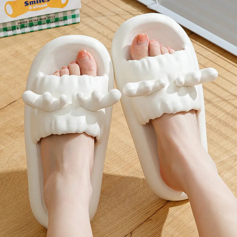 Pair of light-coloured EVA flip flop slippers with hollow-out design and textured sole.