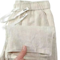 Pure linen Chinese style trousers with elastic drawstring waist in apricot colour showing long straight leg design